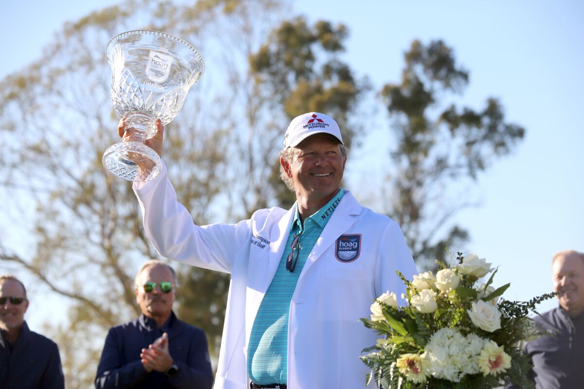 Retief Goosen holds up the championship trophy after winning the Hoag Classic at Newport Beach Country Club on Sunday.