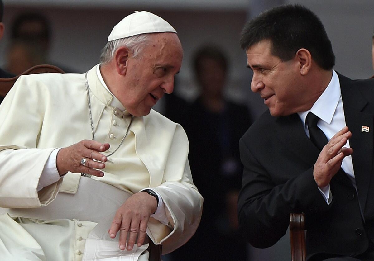 Pope Francis chats with Paraguay's President Horacio Cartes during the welcoming ceremony in Asuncion on July 10 .