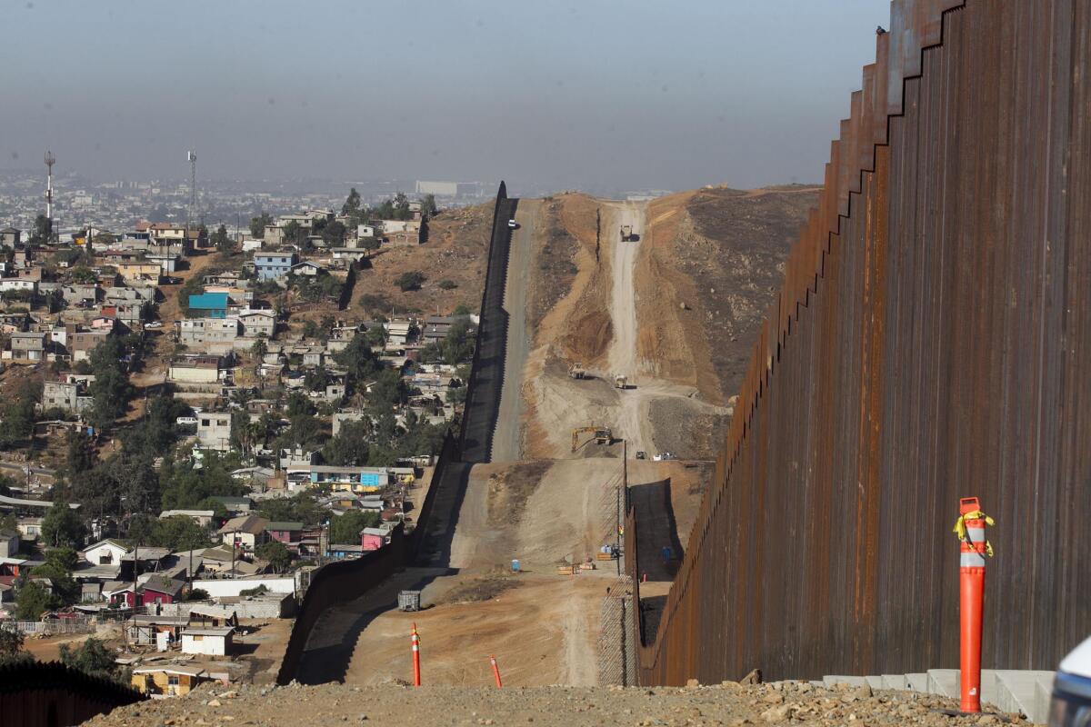 A U.S.-Mexico border fence under construction.