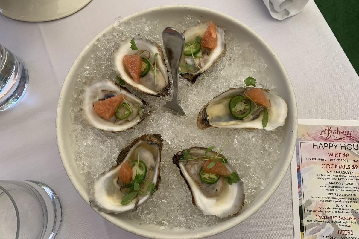 Oysters at La Boheme come topped with slivers of grapefruit, serrano chiles and cilantro with a shio ponzo sauce.