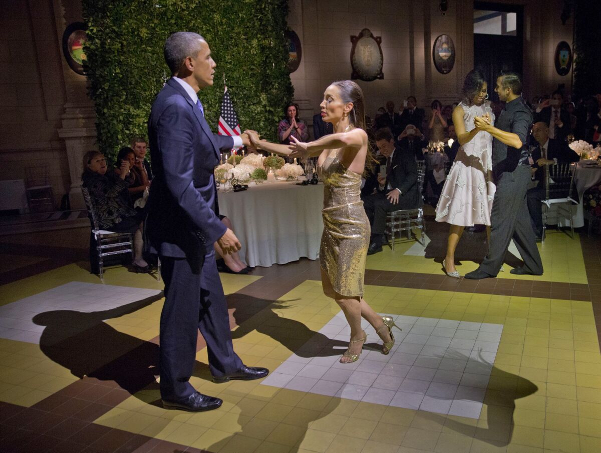 President Obama and First Lady Michelle Obama, at right, dance the tango at a state dinner in Buenos Aires.