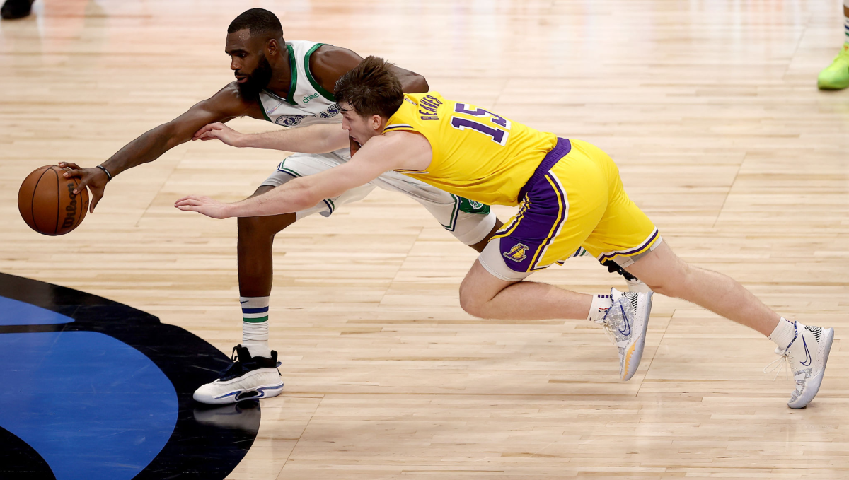 Lakers guard Austin Reaves scrambles for a loose ball against Dallas Mavericks small forward Tim Hardaway Jr.