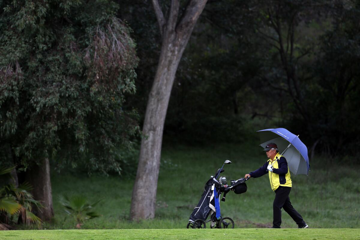 Kam Song plays a round by himself at the Wilson and Harding golf courses in Griffith Park.