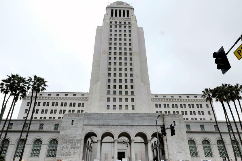 Protesters stand on the steps of Los Angeles City Hall on Monday, Feb. 20, 2017. Demonstrators gathered to express their opposition to President Donald Trump and take part in a ''Not My President's Day'' rally. (AP Photo/Richard Vogel)