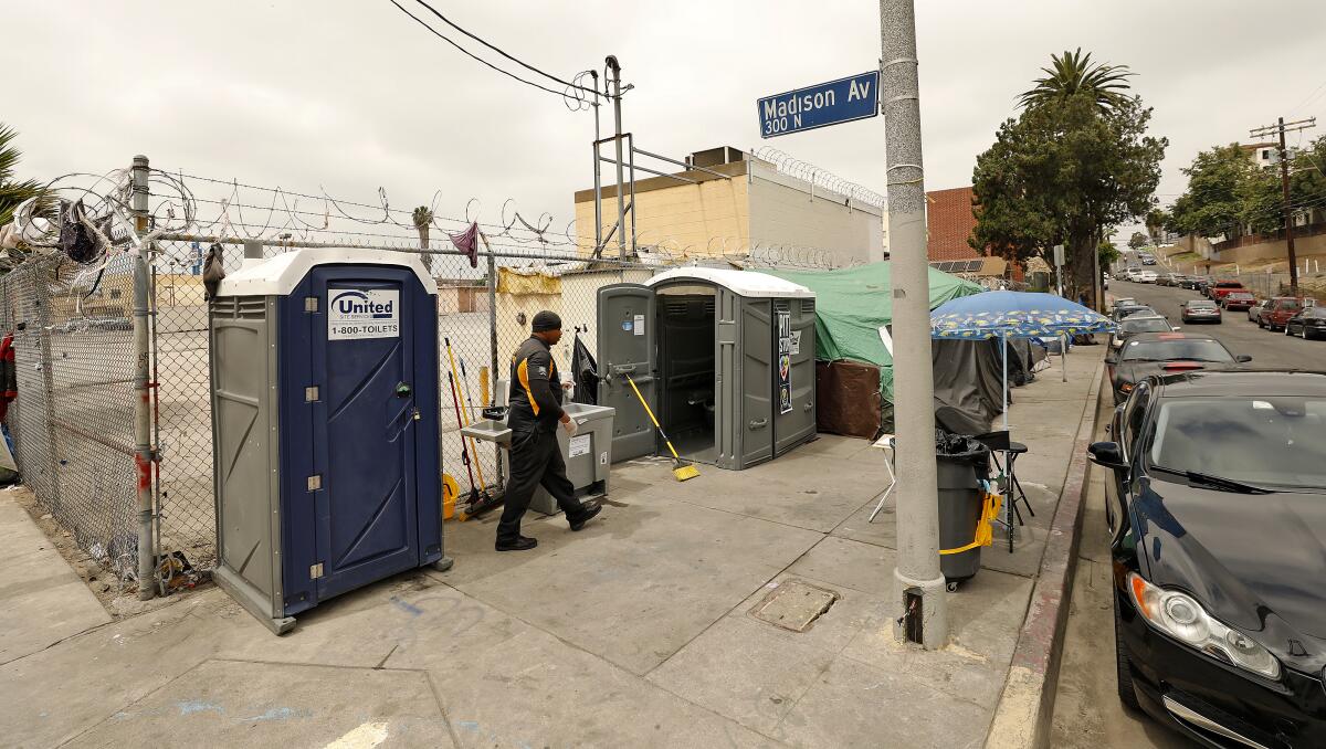 Deandre Fradiue working as an attendant for portable toilets for homeless people in East Hollywood in June 2019.