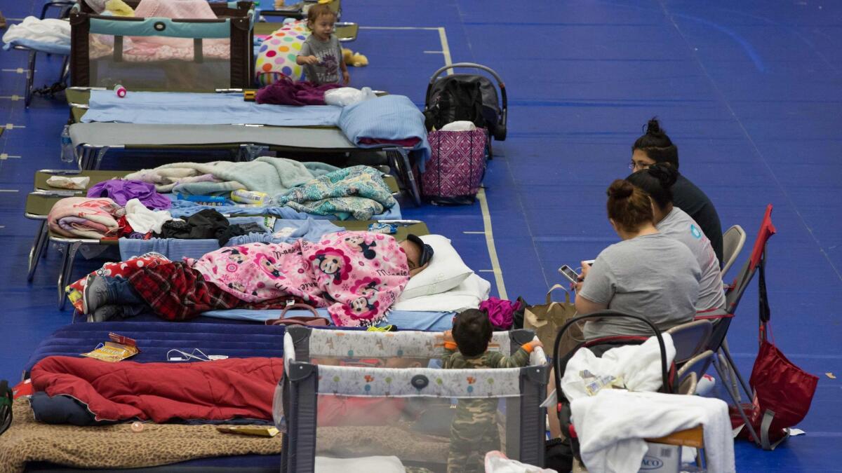 Evacuees take shelter at the Delco Center in Austin, Texas, on Sunday.