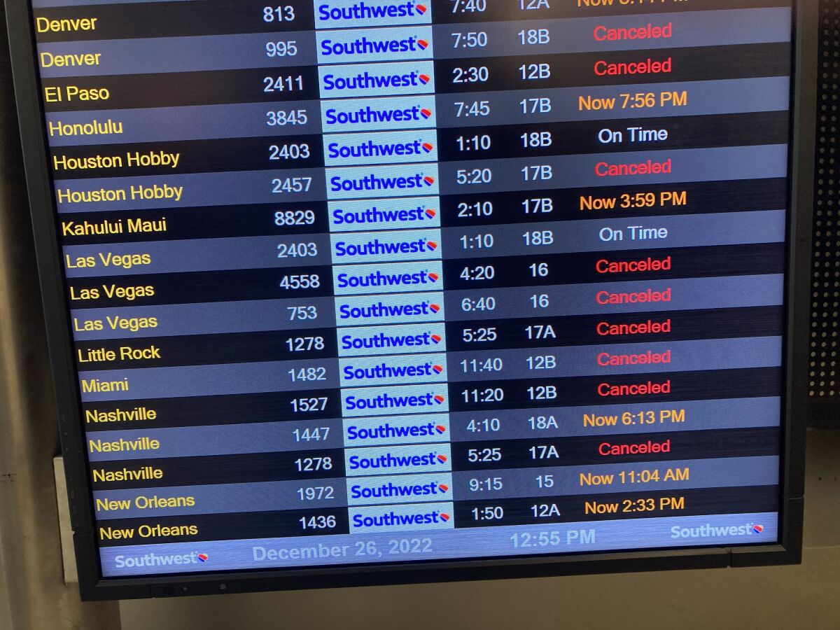 A flight board shows canceled flights at the Southwest Airlines terminal on at LAX.