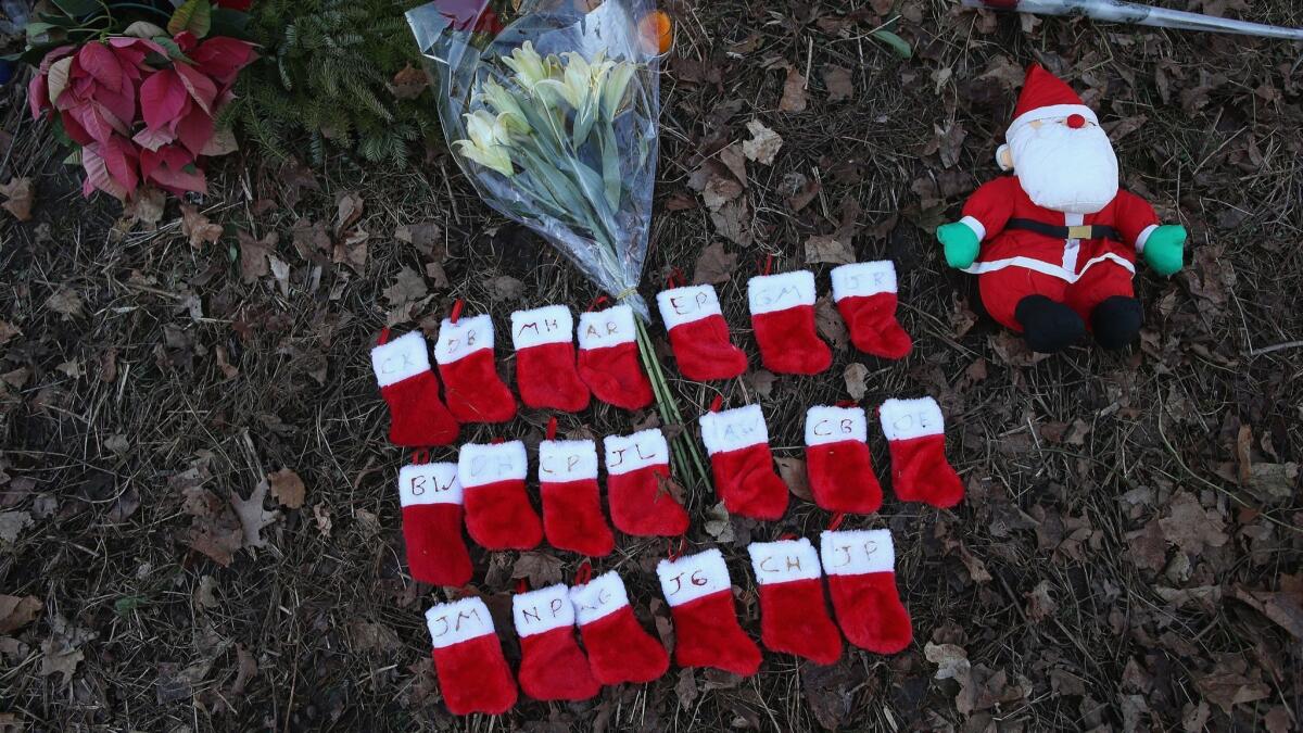 NEWTOWN, CT - DECEMBER 19: Twenty miniature stockings adorn a makeshift memorial for the mass shooting victims on December 19, 2012 in Newtown, Connecticut. Adam Lanza reportedly shot his mother Nancy Lanza last Friday before he killed 26 others, including 20 children, at Sandy Hook Elementary School. (Photo by John Moore/Getty Images) ORG XMIT: 158706534