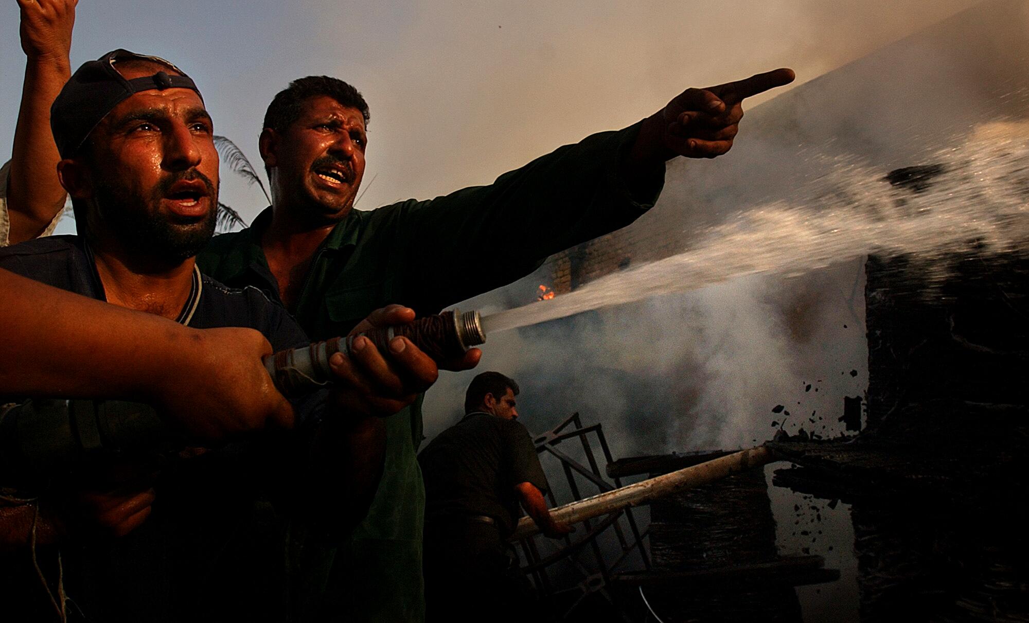 Firefighters battle a fire at the Ministry of Transportation storage department that was caused by looters in Baghdad, Iraq.