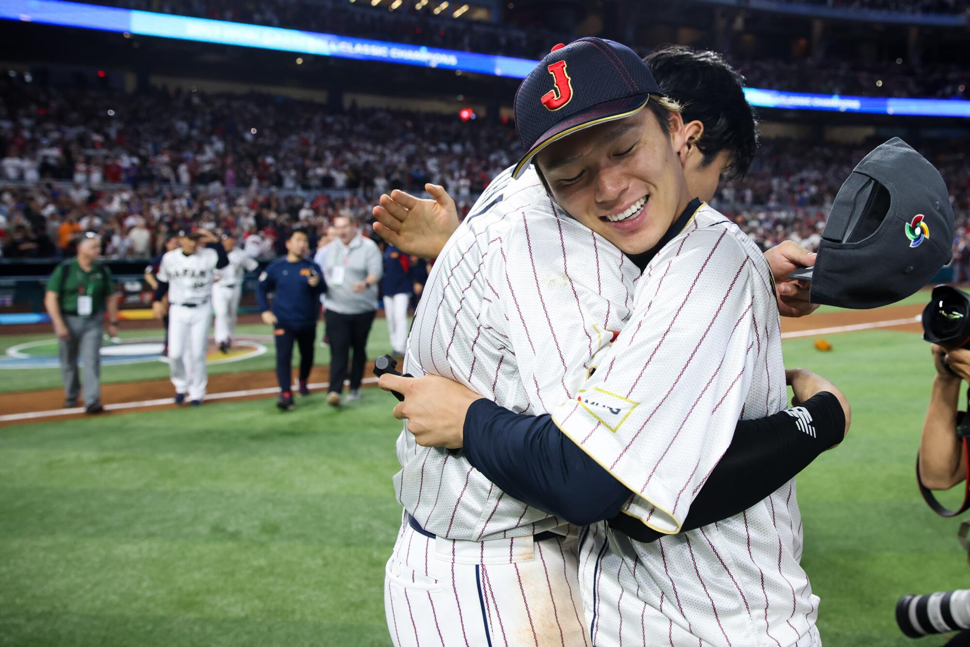 Shohei Ohtani, left, hugs Yoshinobu Yamamoto after Japan's victory over the U.S.