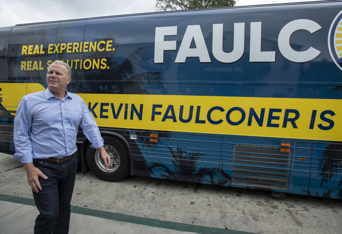 Former San Diego Mayor Kevin Faulconer walks back to his bus after a campaign stop in Whittier on Aug. 21. 