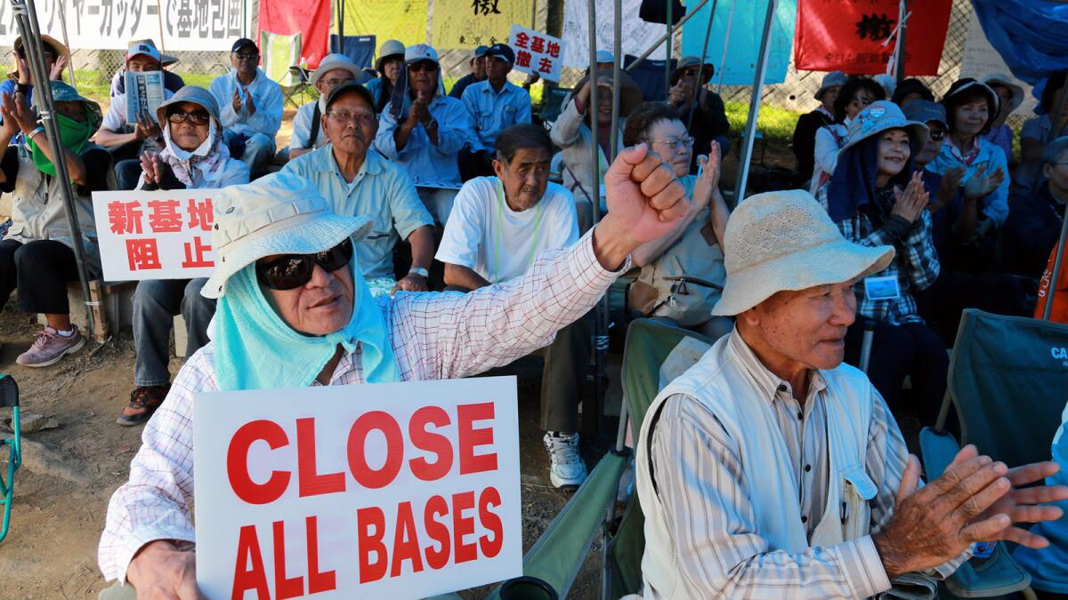 Protesters stage a demonstration outside the U.S. Marine Corps' Camp Schwab on Okinawa island, southern Japan, on Monday.