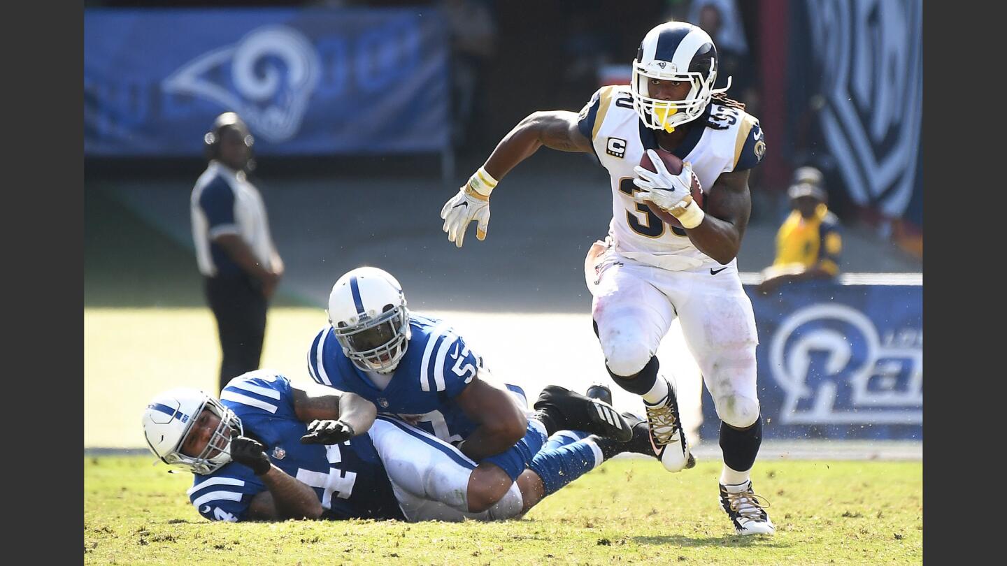 Rams running back Todd Gurley breaks away from two Colt defenders to pick up yards during the fourth quarter.