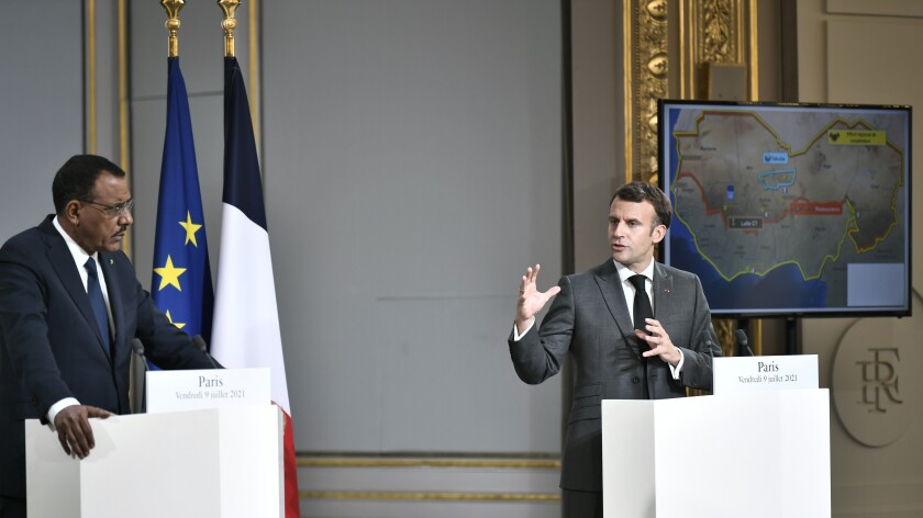 French President Emmanuel Macron, right, and Niger's President Mohamed Bazoum hold a press conference after a video summit with leaders of G5 Sahel countries at the Elysee presidential Palace in Paris, Friday July 9, 2021. French President Emmanuel Macron said Friday his country will withdraw more than 2,000 troops from an anti-extremism force in Africa's Sahel region starting in the coming months. Macron announced last month a future reduction of France's military presence, arguing that the current operation is no longer adapted to the need. (Stephane de Sakutin, Pool photo via AP)