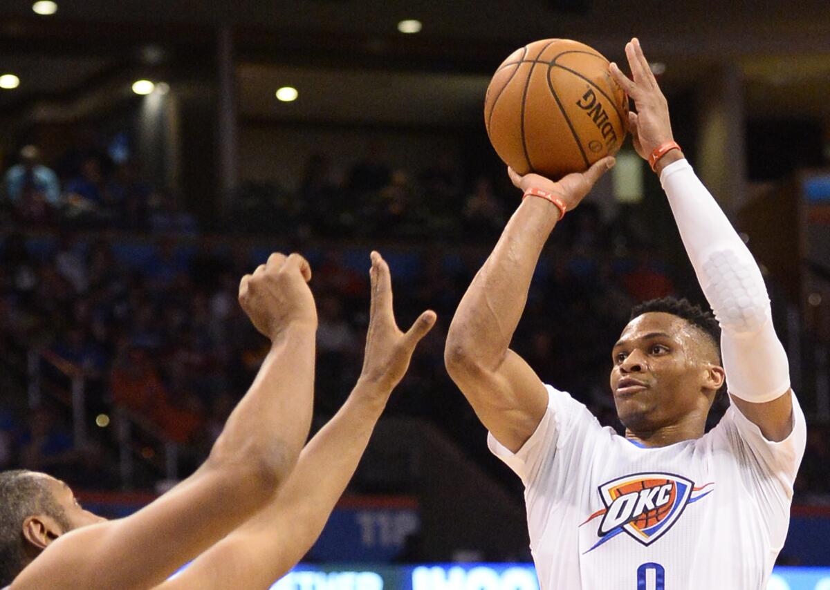 Thunder point guard Russell Westbrook shoots over Spurs defender Boris Diaw in the first half of a game on March 26.