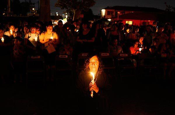 Rigoberto Ruelas' mother Rita holds a candle during a candlelight vigil for the Miramonte Elementary School teacher who committed suicide. See full story