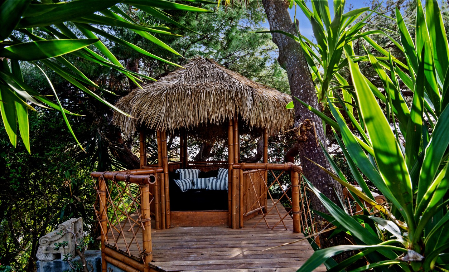 The contemporary-style home, developed by former Hollywood duo Janus Cercone and Michael Manheim, sits on a lush, one-acre lot in Malibu with 270-degree ocean views. Tropical landscaping creates a backdrop for an adult treehouse, hidden pathways and a hammock installed between two trees. There's also a 12-person spa and an infinity-edge pool that can be controlled by a smartphone. Listed for $11.45 million, the single-story house was redesigned so that all but one room takes in a view of the ocean, while skylights were added to bathe the interior in natural light. Among features is a custom Moroccan amethyst geode sink in the powder room. The unique sink fixture is fed by a ceiling faucet.