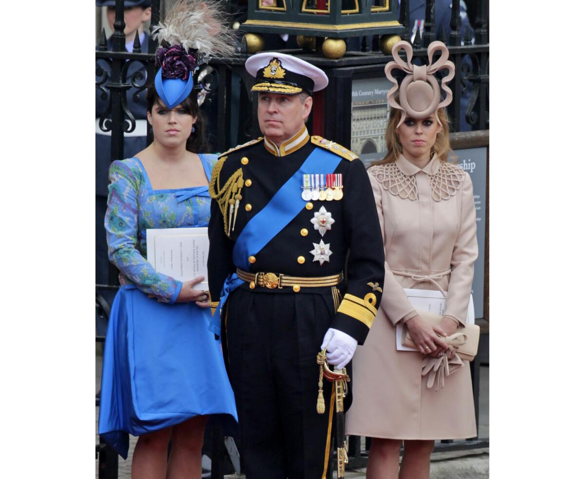 April, 29, 2011: Britain's Prince Andrew and his daughters, Princess Eugenie, left, and Princess Beatrice, leave Westminster Abbey after the nuptials.