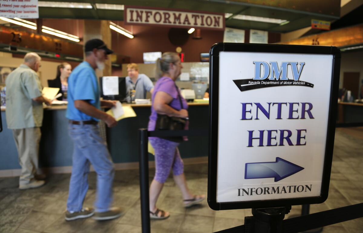Las Vegas residents enter the Department of Motor Vehicles to renew vehicle registration and drivers licenses.