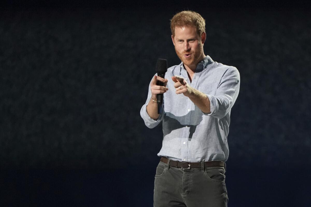 A smiling Prince Harry speaks at 'Vax Live'