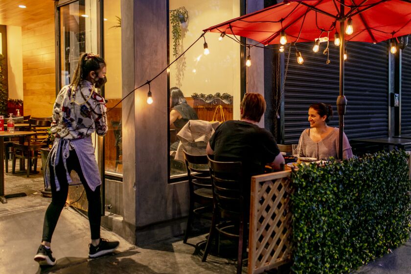 LOS ANGELES, CALIFORNIA - Apr. 30, 2021: Diners enjoy their dinner on Ruam Mitr's two-table sidewalk patio on Friday, Apr. 30, 2021, at the Thai restaurant on Melrose Ave., in Fairfax, Los Angeles. (Silvia Razgova / For the Times) ATTN: 765734-la-fo-spring-dining-Ruam-Mitr-Thai