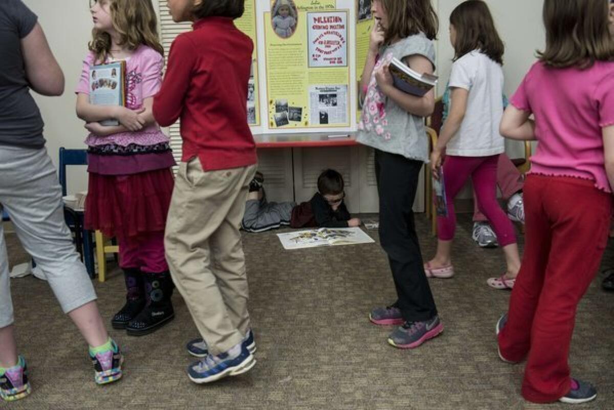 Girls wait at an American Girl series book signing in April at the Arlington Library in Arlington, Va. Girls of all races are entering puberty earlier than ever before, and new suggests that obesity may be a contributing factor.