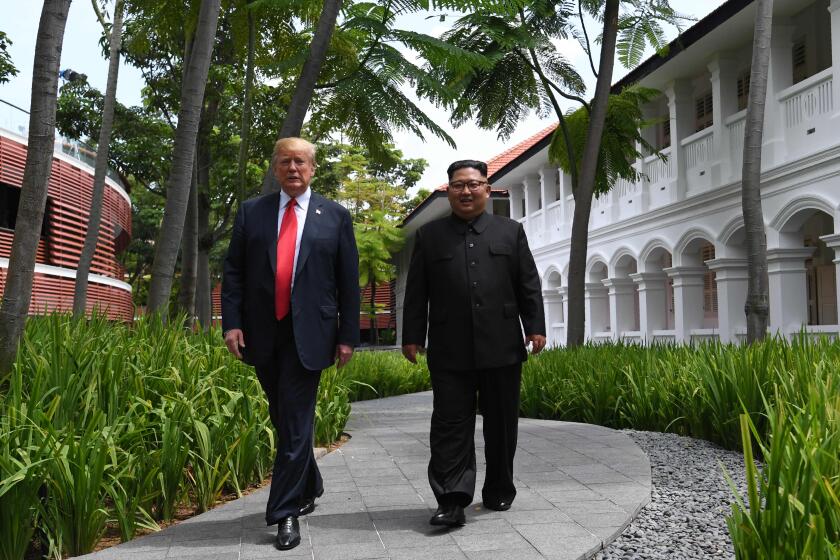 TOPSHOT - North Korea's leader Kim Jong Un (R) walks with US President Donald Trump (L) during a break in talks at their historic US-North Korea summit, at the Capella Hotel on Sentosa island in Singapore on June 12, 2018. Donald Trump and Kim Jong Un became on June 12 the first sitting US and North Korean leaders to meet, shake hands and negotiate to end a decades-old nuclear stand-off. / AFP PHOTO / SAUL LOEBSAUL LOEB/AFP/Getty Images