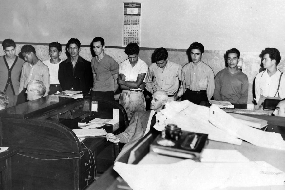 Accused: Here is another group of the youthful gangster suspects as they appeared for arraignment (published Aug. 11, 1942). Left to right are Daniel Verdugo, Edward Cranpre, Manuel Delgado, Jack Melendez, Joseph W. Valenzuela, Andrew Acosta, Joe Herrera, Richard Castelum, Lupe Orusco and Benny Alvarez. Note how youths bow their heads. (NOTE: Orusco is now the caption spells it)