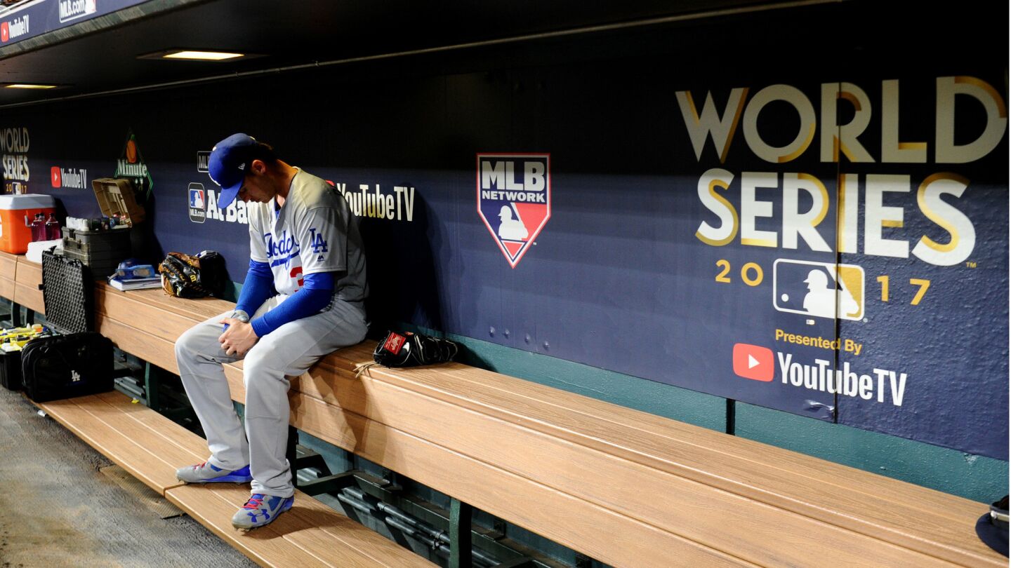 Cody Bellinger sits in the Dodgers dugout before Game 4.
