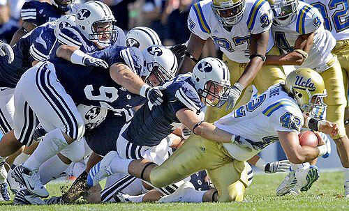 UCLA running back Chane Moline gains no yardage as several Brigham Young defenders bring him down during the fourth quarter Saturday. UCLA has 38 yards rushing, averaging 0.8 yards a carry, in two games.
