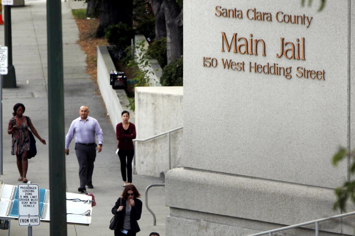 People walk outside the Santa Clara County Main Jail in San Jose.