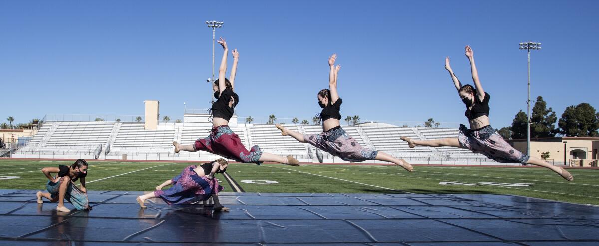 Dancers perform in a socially distanced setting at Cap Sheue Field at Huntington Beach High for filming of "Fusion."