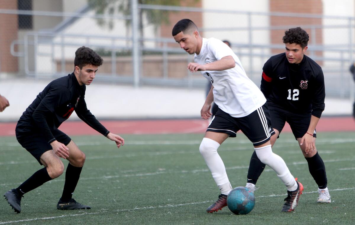 Burroughs High School soccer player Manny Gonzalez tries to get through the defense in game vs. Glendale High in Glendale on Tuesday, Jan. 21, 2020.