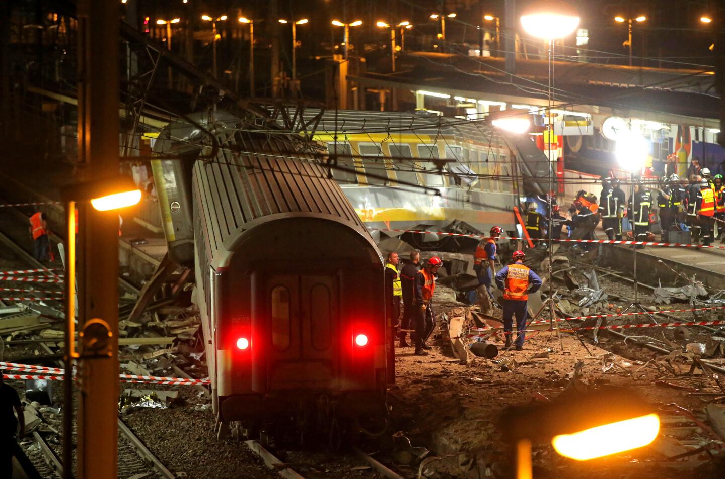 A derailed train car rests at the station in Bretigny-sur-Orge, 12 miles south of Paris. The packed passenger train skidded off its rails soon after leaving Paris, leaving at least six dead and dozens injured, authorities said.