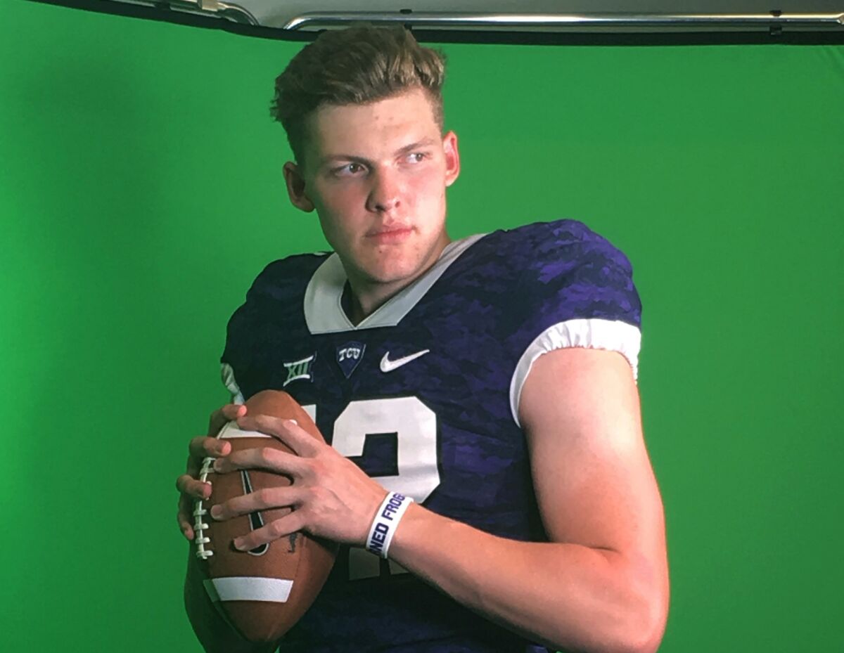 In this photo taken on July 27, 2019, German quarterback Alexander Honig poses for a photo ina TCU uniform after participating in a football camp at the Big 12 Conference school in Fort Worth, Texas. TCU offered Honig a scholarship after the workout. Honig looks and sounds the part of big-time American college football recruit. The quarterback is nearly 6-foot-6 and 235 pounds. He has a scholarship offer to play at TCU. But the unusual part is Honig is German. It's rare for an American college program to recruit a European as a quarterback. The 18-year-old Honig is taking his talents from Bavaria to Texas with dreams of becoming an NFL QB. (Susanne Honig via AP)