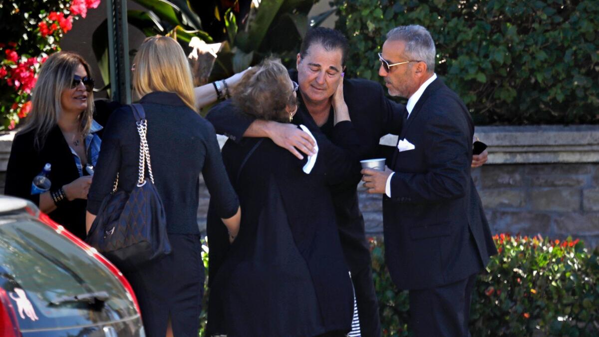 Family members greet one another before the memorial and burial for Meadow Pollack, 18, one of the shooting victims at Marjory Stoneman Douglas High School.