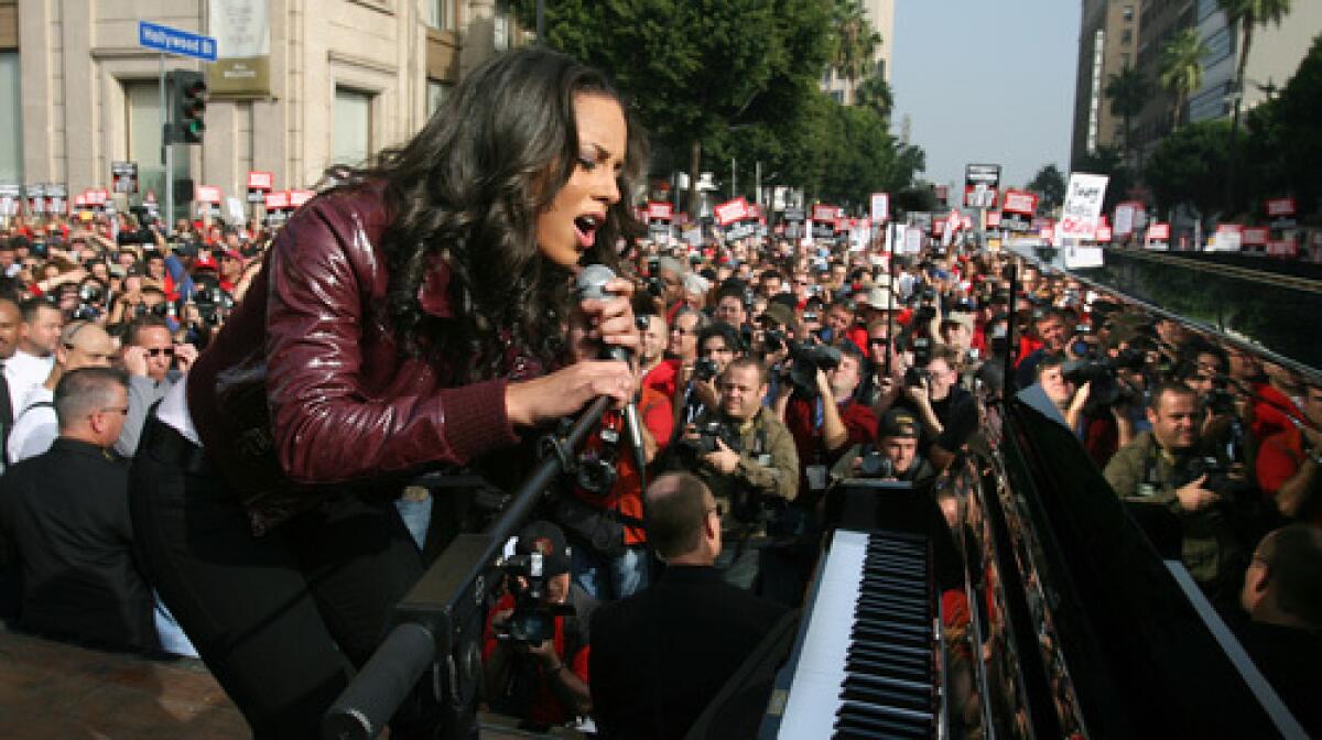 Singer Alicia Keys performs during a protest in support of the WGA on Hollywood Boulevard.