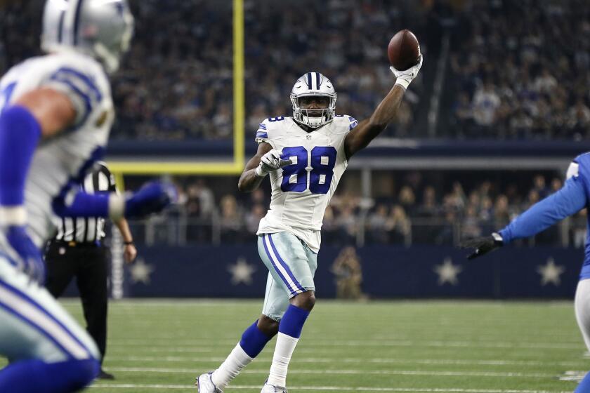 Cowboys receiver Dez Bryant (88) throws a touchdown pass to tight end Jason Witten, left, during the second half Monday.
