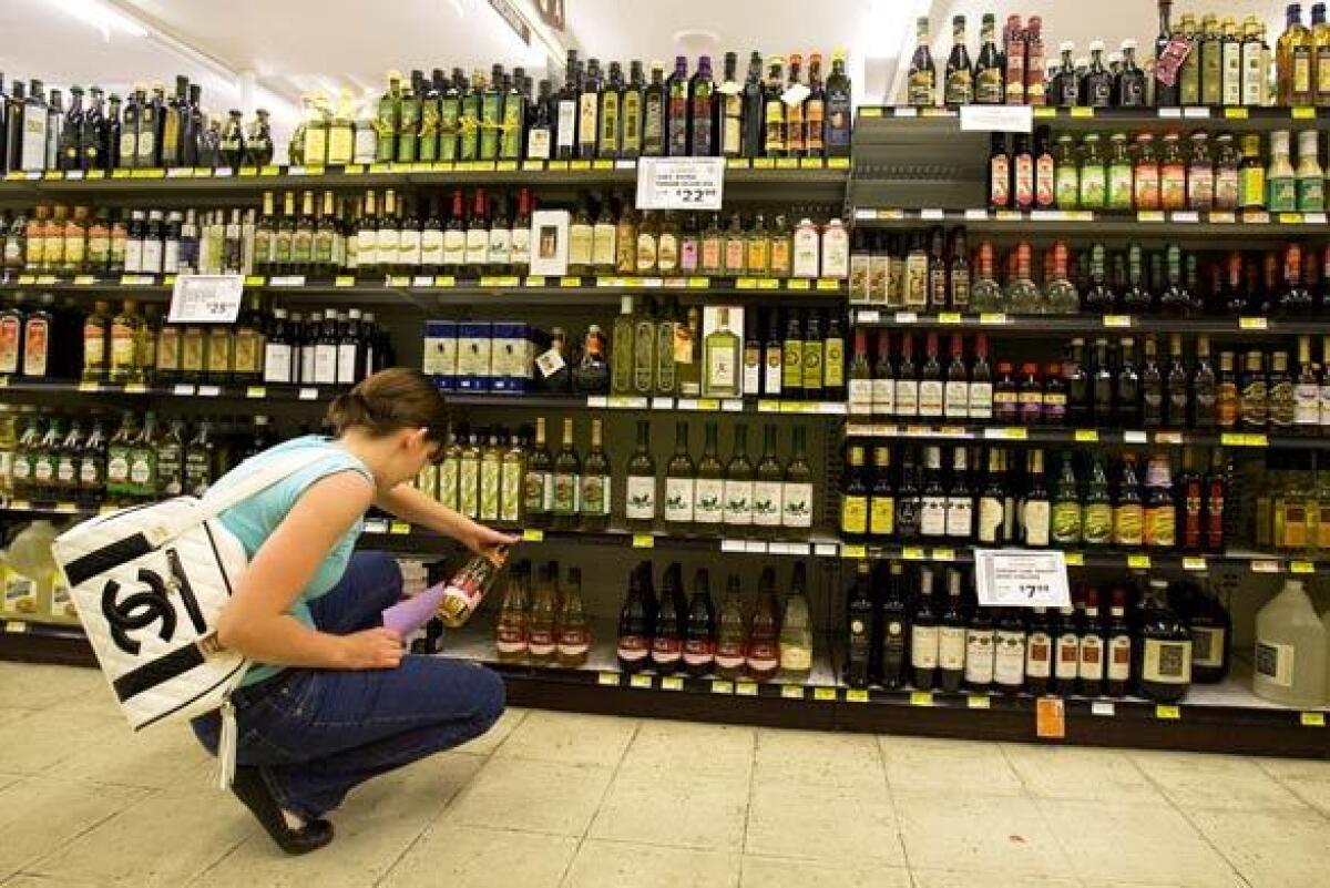 A customer searches the olive oil aisle.