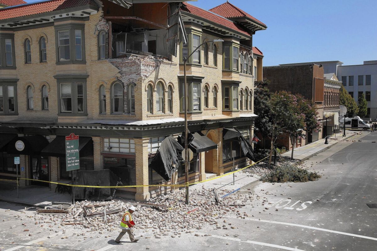 Dan Kavarian, chief building official for the city of Napa, Calif., surveys the damage to buildings in the city's downtown. Inspectors red-flagged at least 15 commercial buildings and 100 homes that were deemed unsafe to enter.