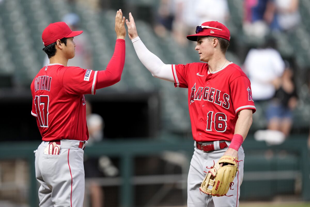 Angels teammates Shohei Ohtani, left, and Mickey Moniak celebrate a 12-5 win over the Chicago White Sox on May 31.