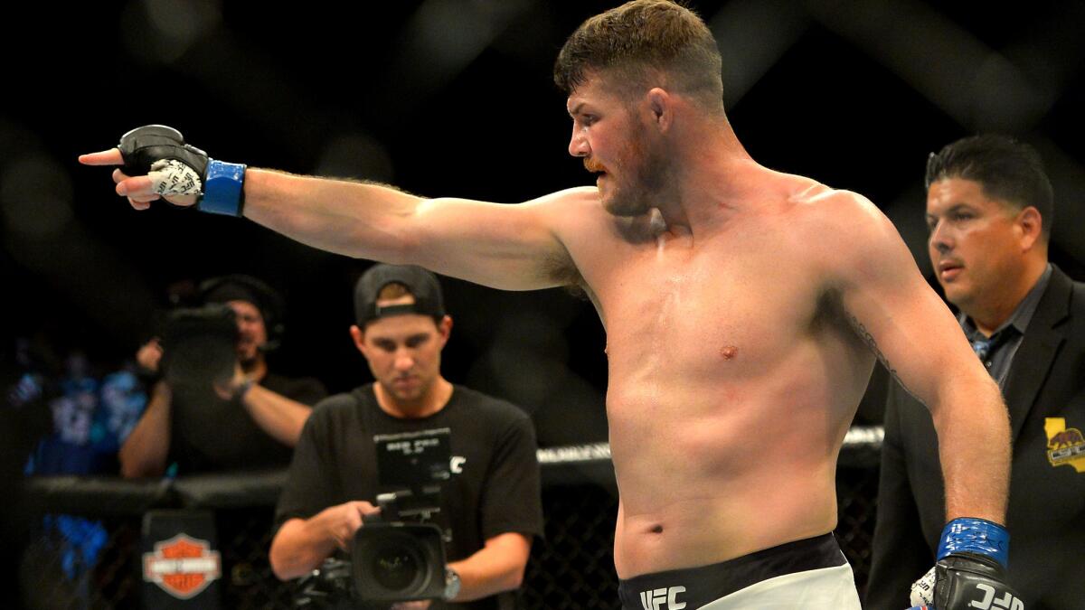 Michael Bisping celebrates after defeating Luke Rockhold for the middleweight title at UFC 199.