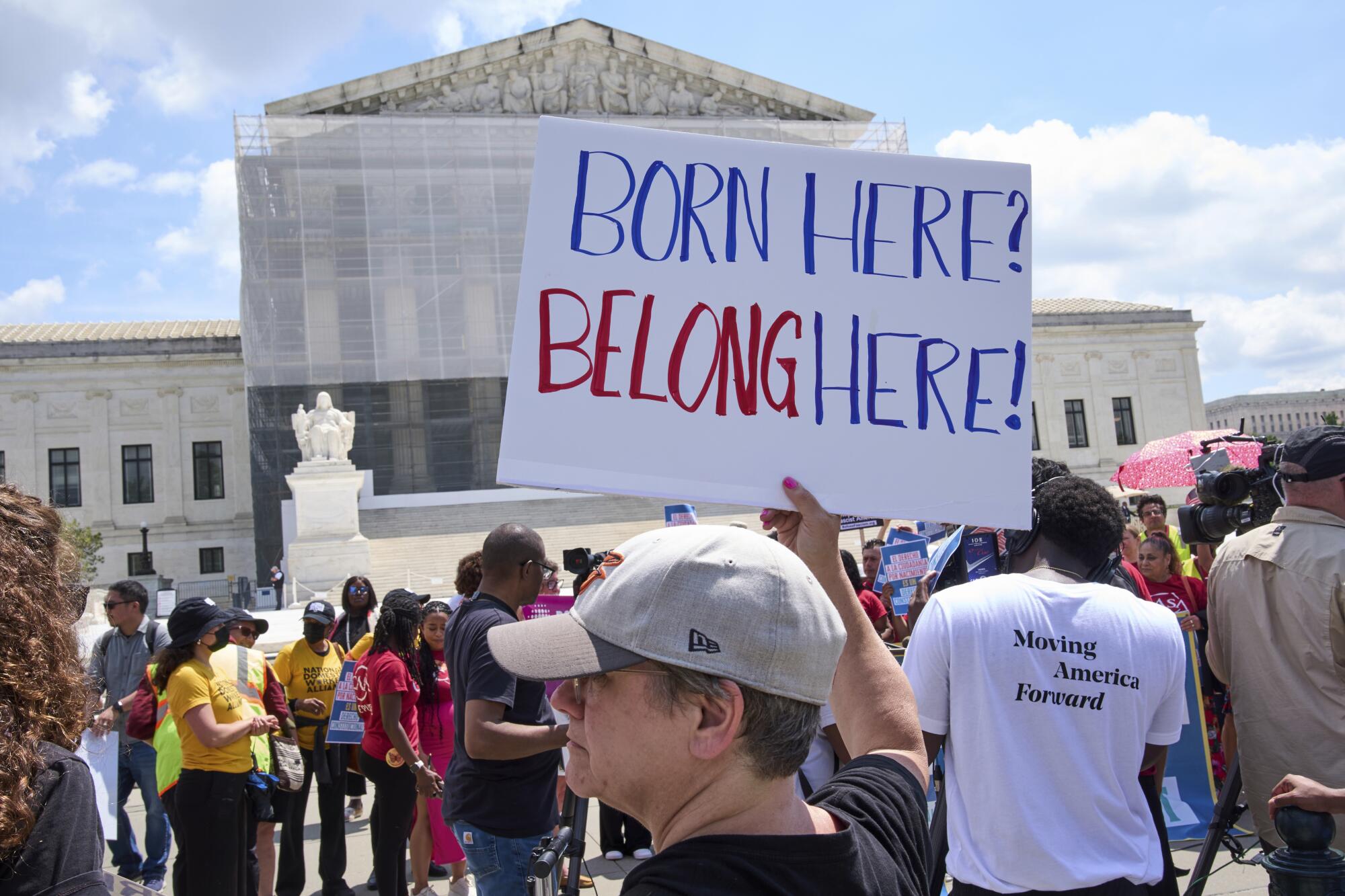 Protesters at Supreme Court with a sign: Born here, belong here