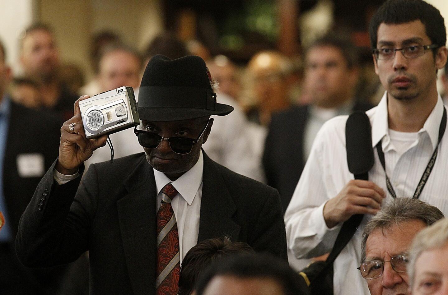 Glendale Howard Grey, 57, uses a tape recorder to document the opening of the renovated Dunbar Hotel in South Los Angeles.