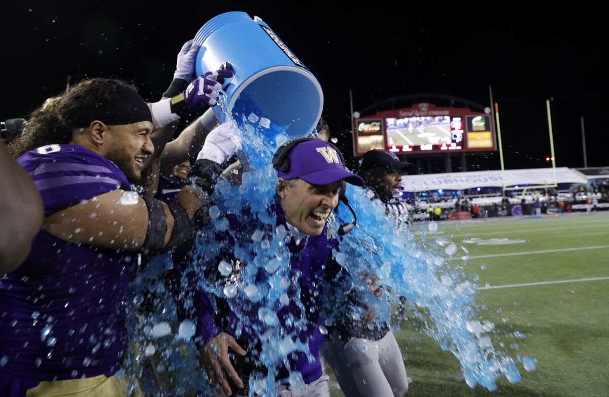 Washington head coach Chris Petersen is doused with a blue sports drink at the 2019 Las Vegas Bowl 