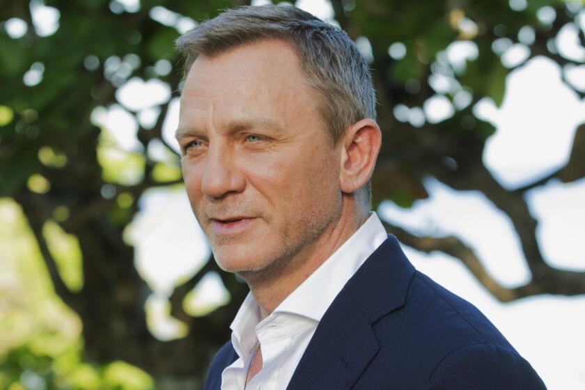 FILE - In this April 25, 2019, file photo, actor Daniel Craig poses for photographers during the photo call of the latest installment of the James Bond film franchise, currently known as "Bond 25," in Oracabessa, Jamaica. An explosion Tuesday, June 4, 2019, on the set of the new James Bond movie has injured one crew member and damaged a stage at Pinewood Studios outside London. No one was injured on set but a crew member outside the stage sustained a minor injury. The exterior of a stage was also damaged at the studio facilities. (AP Photo/Leo Hudson, File)