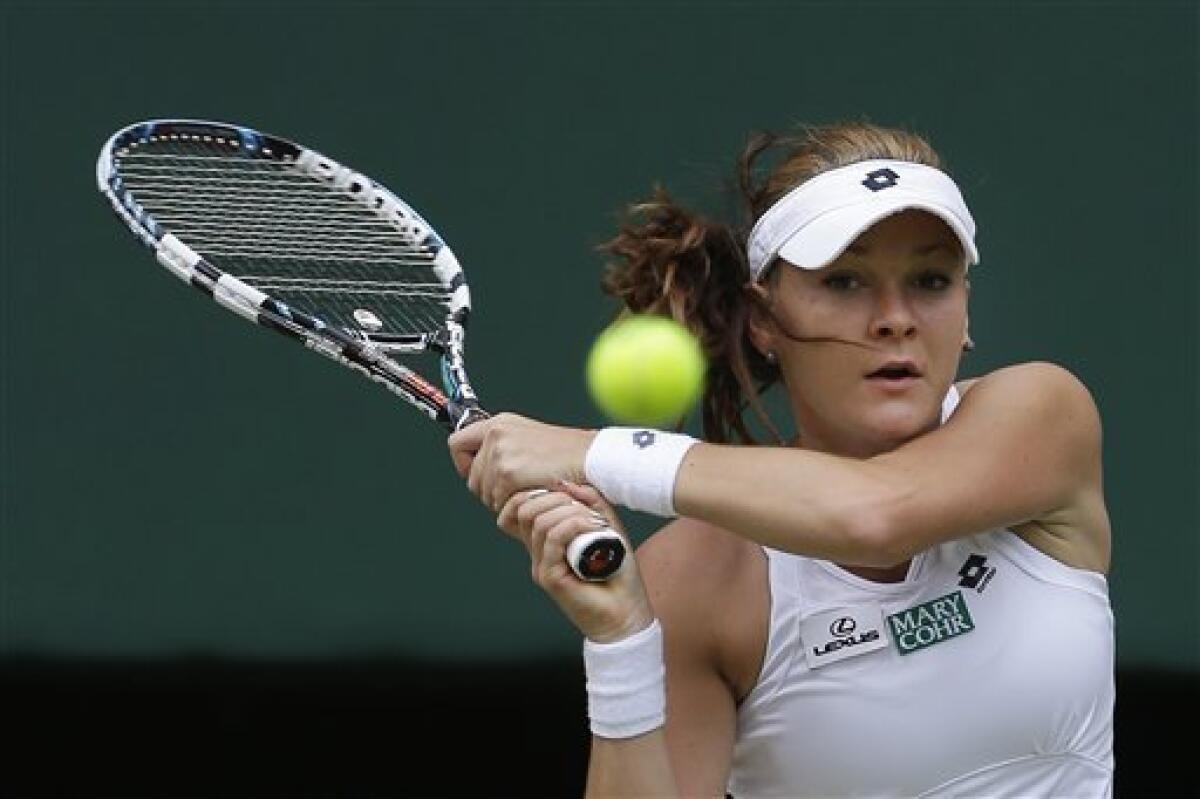 Agnieszka Radwanska of Poland plays a shot to Angelique Kerber of Germany during a semifinals match at the All England Lawn Tennis Championships at Wimbledon, England, Thursday, July 5, 2012. (AP Photo/Alastair Grant)