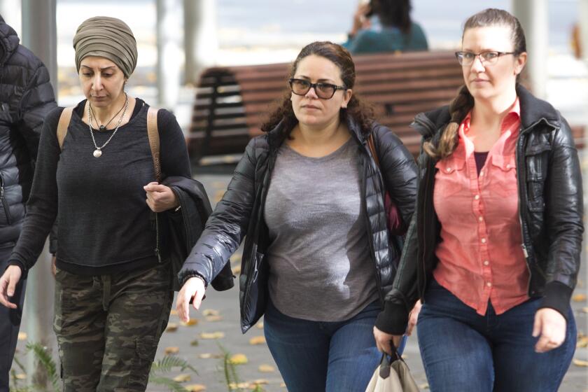 Zeina Abouammo, second left, whose husband, US citizen Ahmad Abouammo, is accused of using his position at Twitter to spy on accounts, arrives for a detention hearing at US District Court, Western District of Washington in Seattle on November 8, 2019. - The allegations of spying by former Twitter employees for Saudi Arabia underscore the risks for Silicon Valley firms holding sensitive data which make the platforms ripe for espionage. The two Saudis and one US citizen allegedly worked together to unmask the ownership details behind dissident Twitter accounts on behalf of Riyadh government and royal family, according to a federal indictment. (Photo by Jason Redmond / AFP) (Photo by JASON REDMOND/AFP via Getty Images)