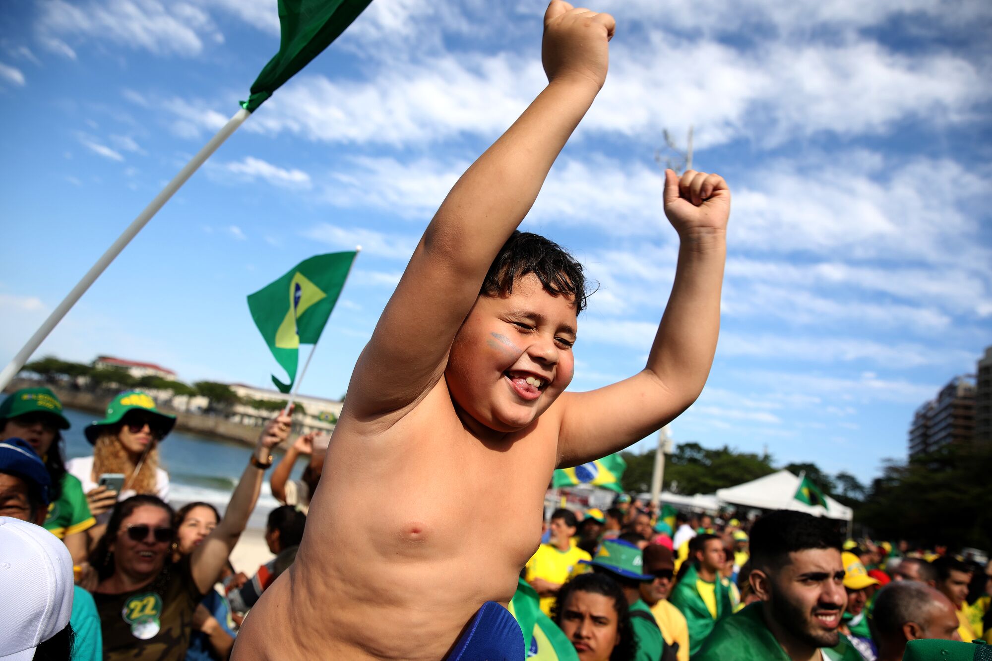 A boy cheers during a rally.