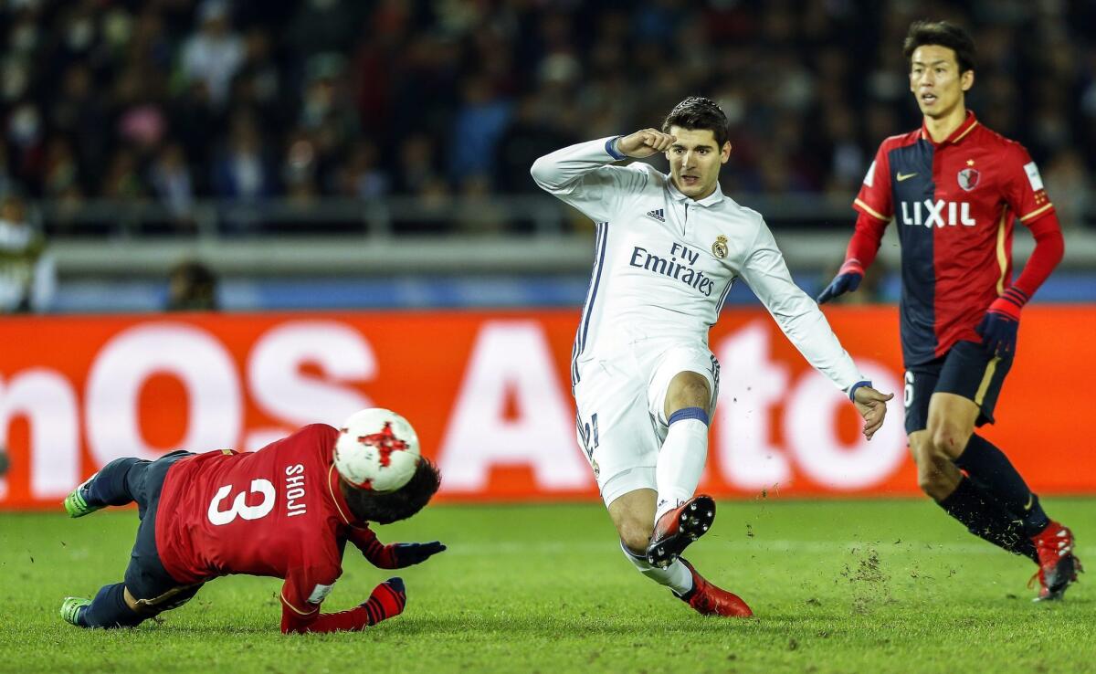 Real Madrid's Alvaro Morata (C) in action against Kashima Antlers' Gen Shoji (L) during the FIFA Club World Cup 2016 final between Real Madrid and Kashima Antlers in Yokohama, Japan, 18 December 2016. Real Madrid won 4-2 after extra time.